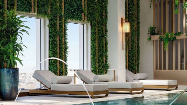 An indoor pool area with lounge chairs, a large potted plant, and vertical greenery on the walls. - Ramada By Wyndham Riyadh King Fahd Road (Riyadh)