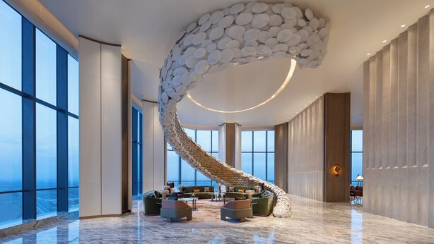 A spacious lobby with a unique spiral staircase, large windows, and modern seating areas. - Wyndham Shanxi Xiaohe Xincheng (Taiyuan)