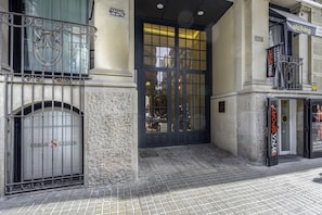 Stunning entrance to a stylish building with a black double door and metal gate.