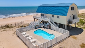 A beach house with a pool, a balcony, and a view of the ocean. - Just Beachy: Beachfront, Private pool, Pet Freindly (St. George Island)