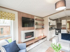 A modern living room with a fireplace, television, and seating area.