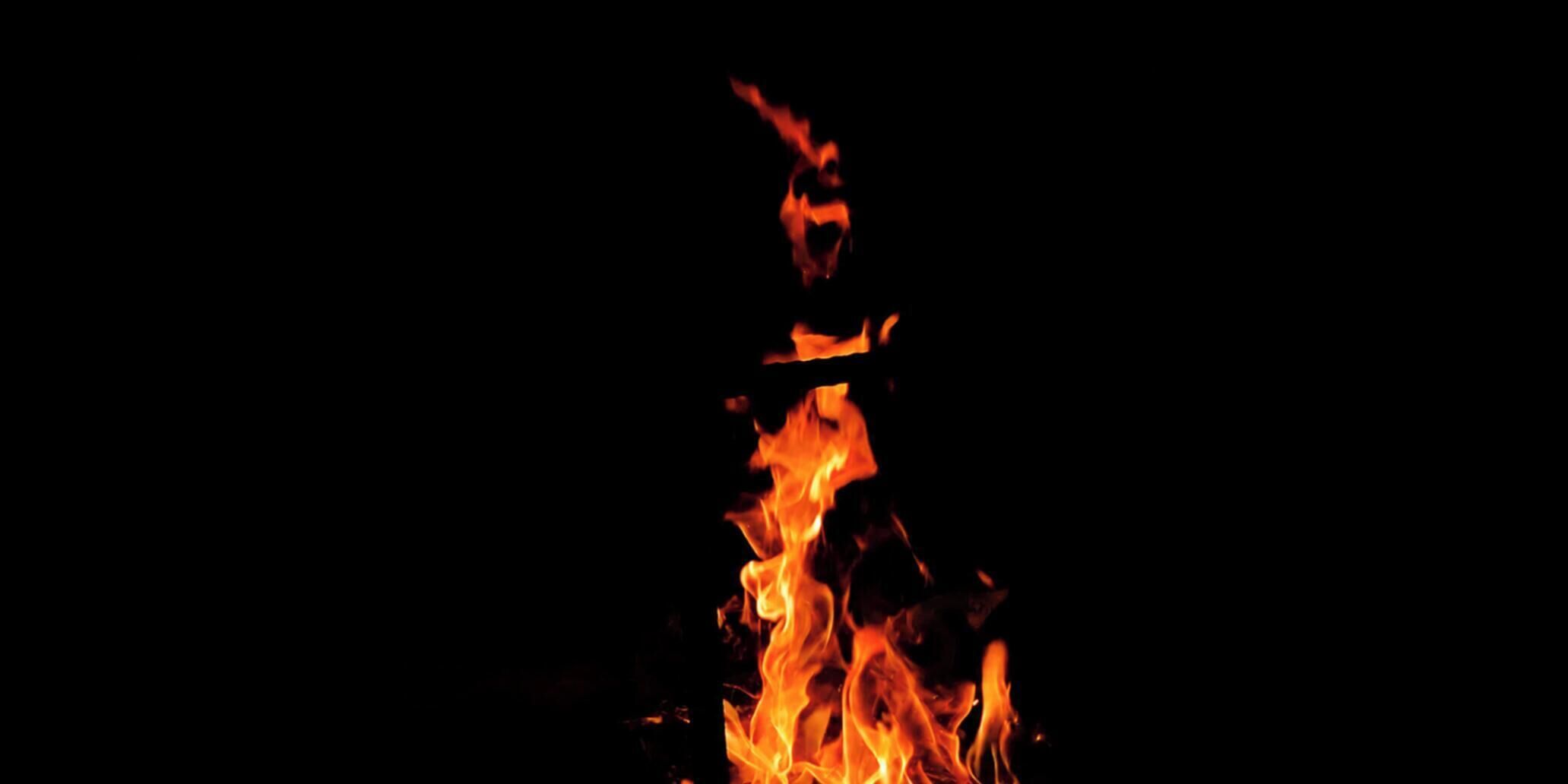 A fire with flames against a dark background.