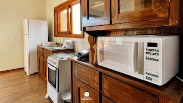 Fridge, microwave, cookware/dishes/utensils, dining tables