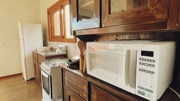 Fridge, microwave, cookware/dishes/utensils, dining tables