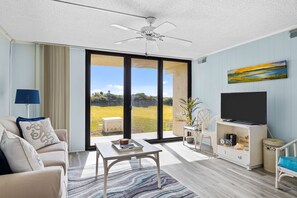 Relax in this inviting living room with a sofa, coffee table, and flat-screen TV.