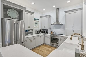 Enjoy cooking in this well-equipped kitchen with a refrigerator, oven, and microwave.