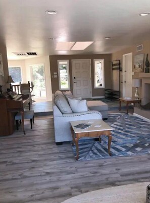 Relax in this stylish living area with a sofa set, coffee table, and patterned rug.