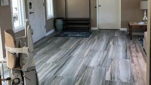 A room with a large window, a bed, a standing exercise machine, and a door. - Beautiful 3,000 Sq Ft Tropical Oasis (El Cajon)