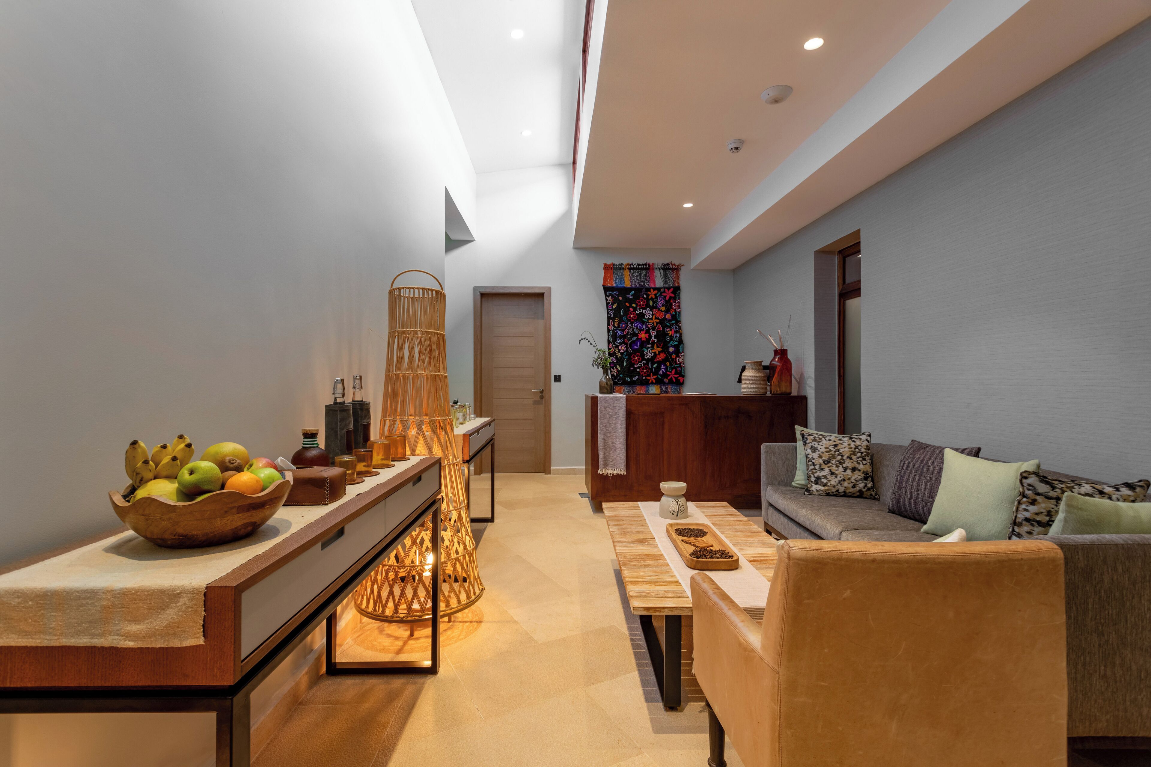 A modern living room with a wooden coffee table, a sofa, and a dining area with a table and chairs.