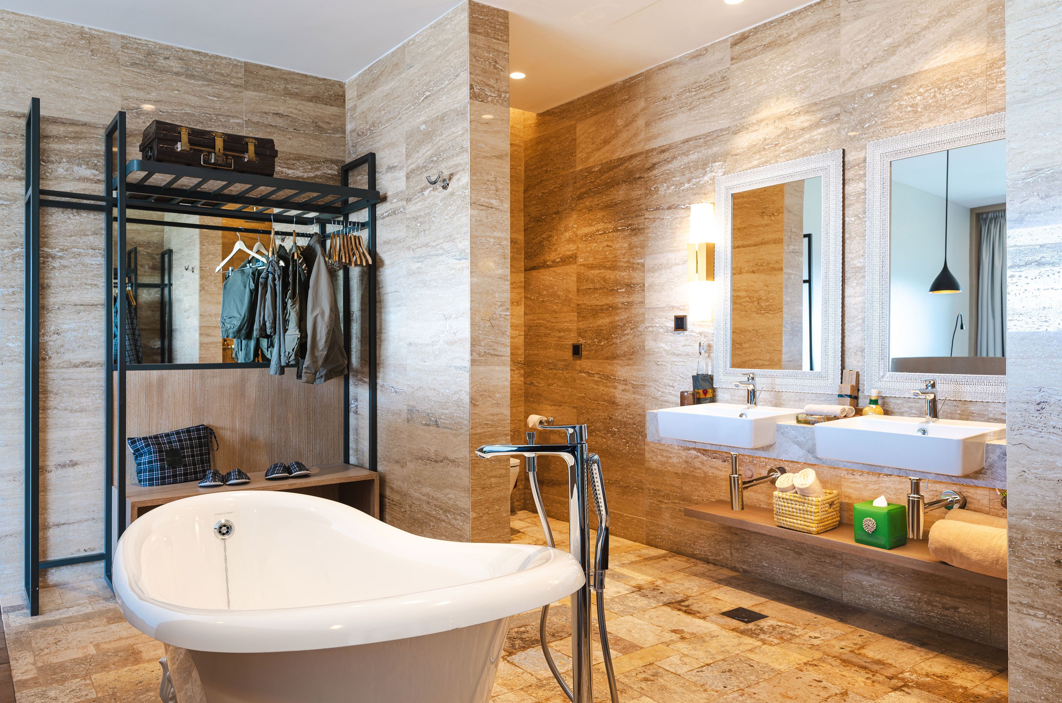 A modern bathroom with a freestanding bathtub, dual sinks, and a mirror above the sinks.