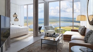 A spacious living room with a large window offering a scenic view, a flat-screen TV, and modern furniture. - Ngorongoro Lodge member of Meliá Collection - The Leading Hotels of the World (Ngorongoro)
