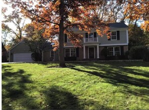 A two-story house with a front porch and a garage.