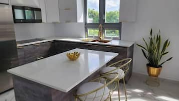 Fridge, microwave, coffee/tea maker, cookware/dishes/utensils