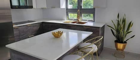 Fridge, microwave, coffee/tea maker, cookware/dishes/utensils