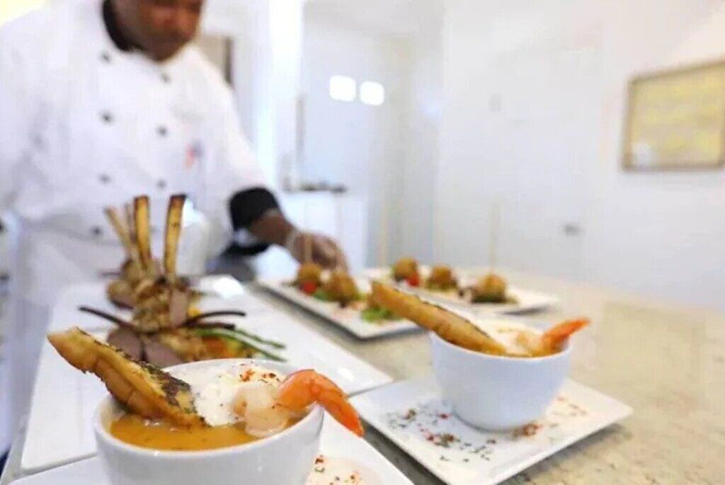 A chef preparing dishes in a professional kitchen setting.