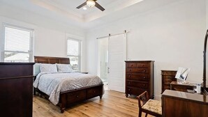A bedroom with a wooden bed, a dresser, a desk, and a chair. - home in fort payne (Fort Payne)