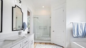 A modern bathroom with a glass shower enclosure, a white sink, and a large mirror. - home in fort payne (Fort Payne)