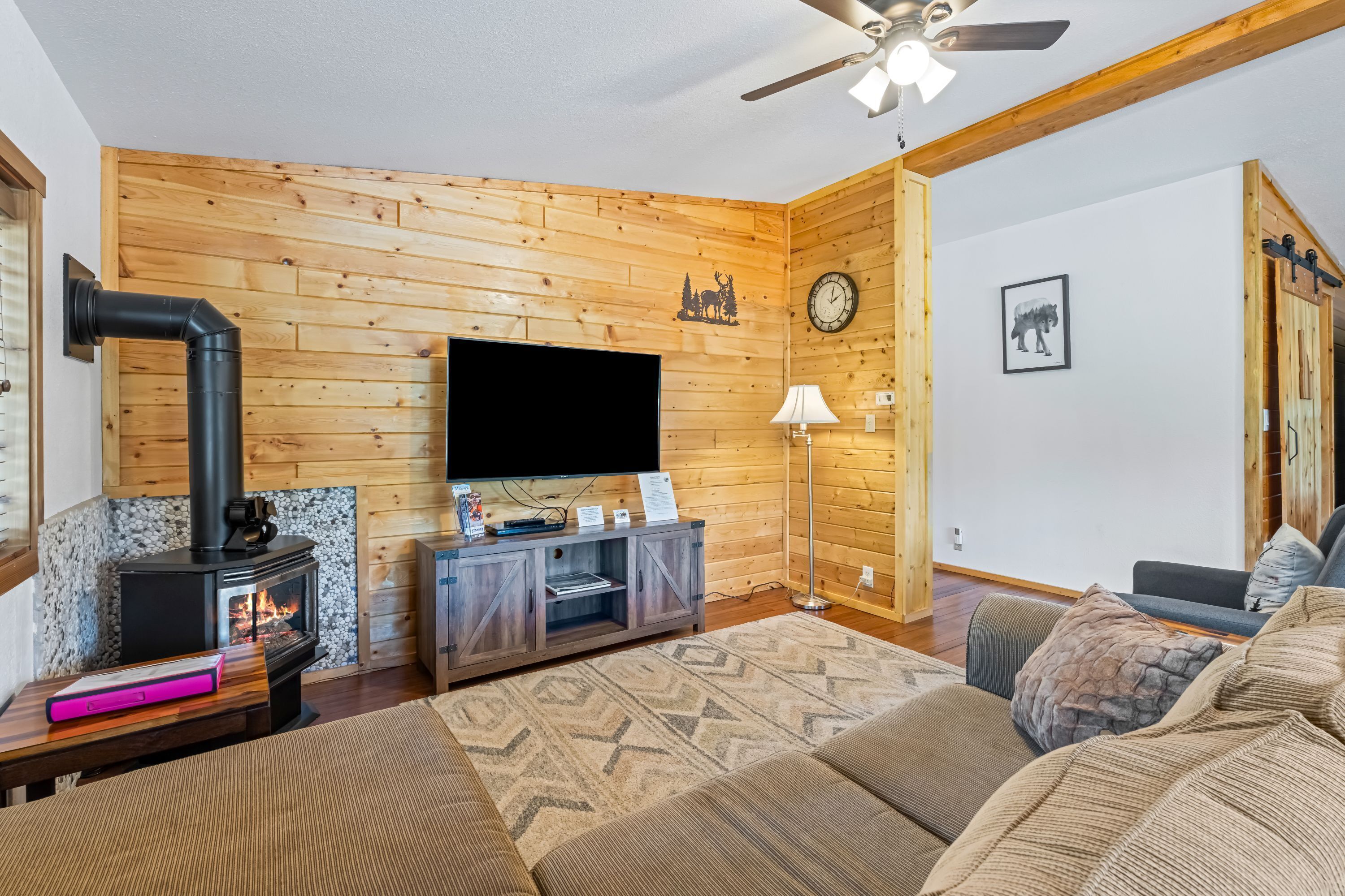A cozy living room with a fireplace, television, and comfortable seating.