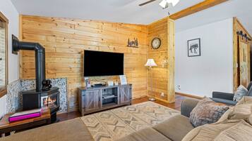 A cozy living room with a fireplace, television, and comfortable seating.