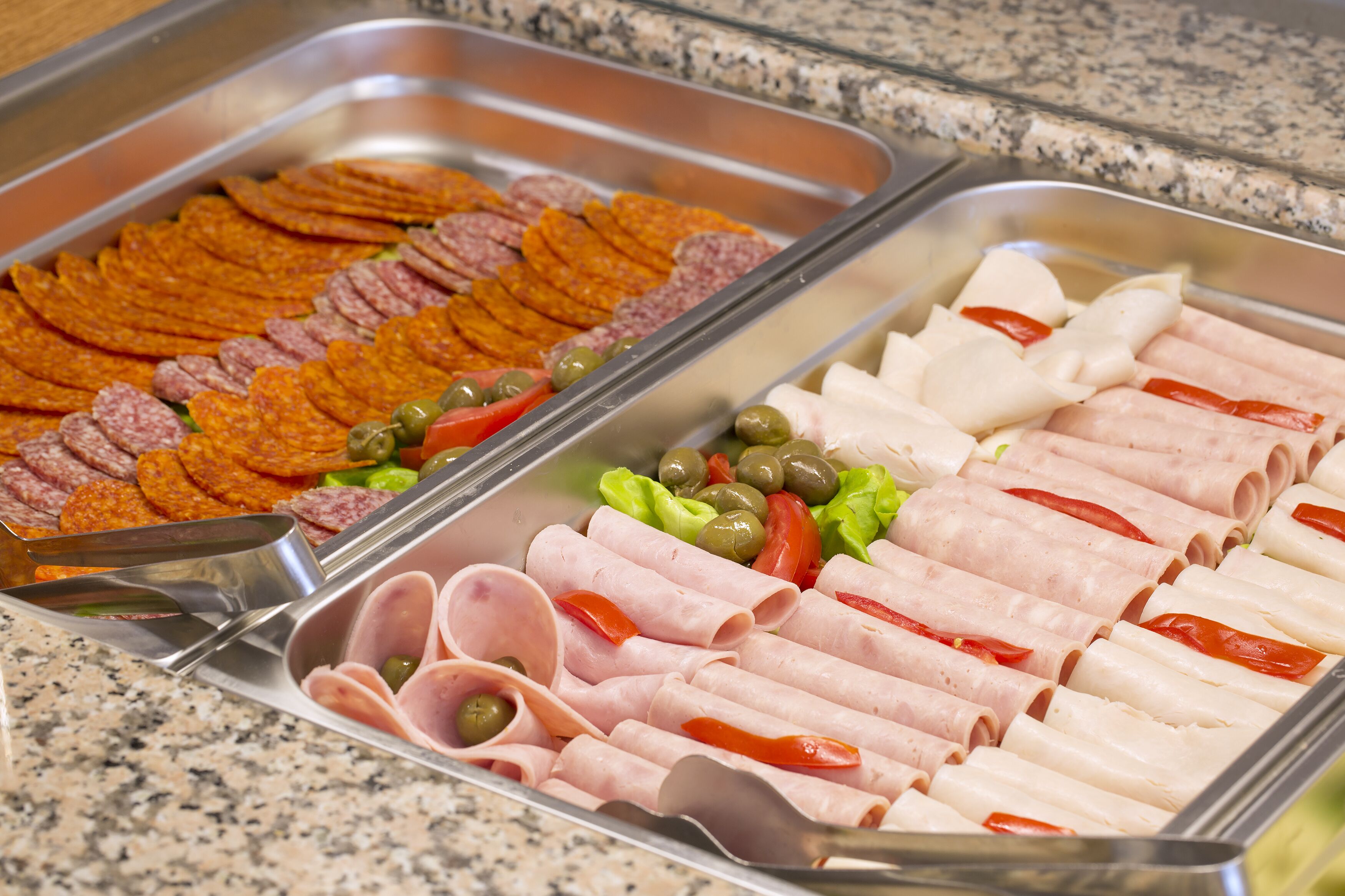 A buffet with various meats and vegetables.