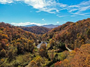 A valley with a river, surrounded by autumn-colored trees and mountains in the background. - Ambleside- Pet friendly, 3 fireplaces, game room, views, lake fishing access (Vilas)