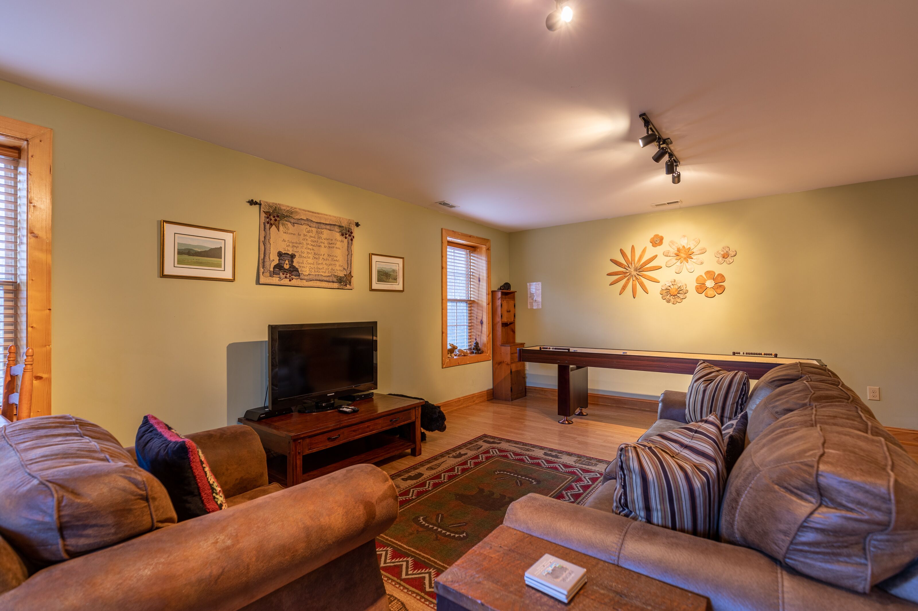 Kick back in the game room lounge at Bear Creek, where comfy leather sofas meet a shuffleboard table for easy mountain evenings.
