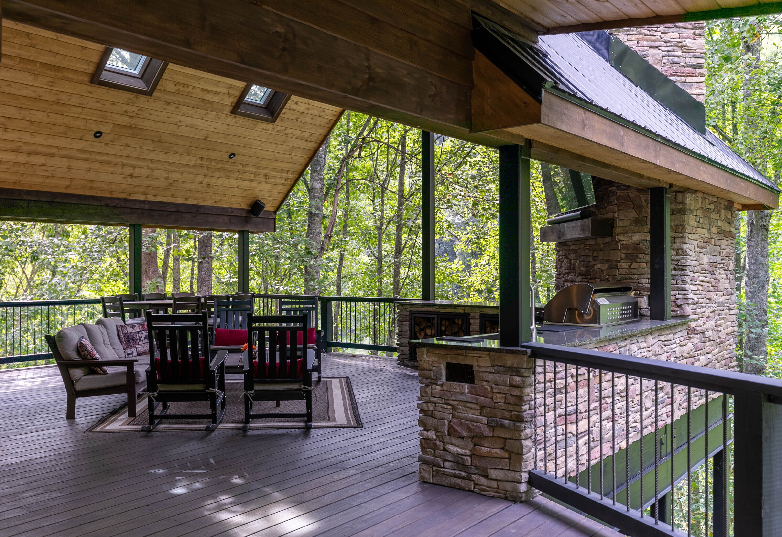Gather, grill, and unwind on the sweeping covered deck at Lakeview, surrounded by lush Blue Ridge woods.