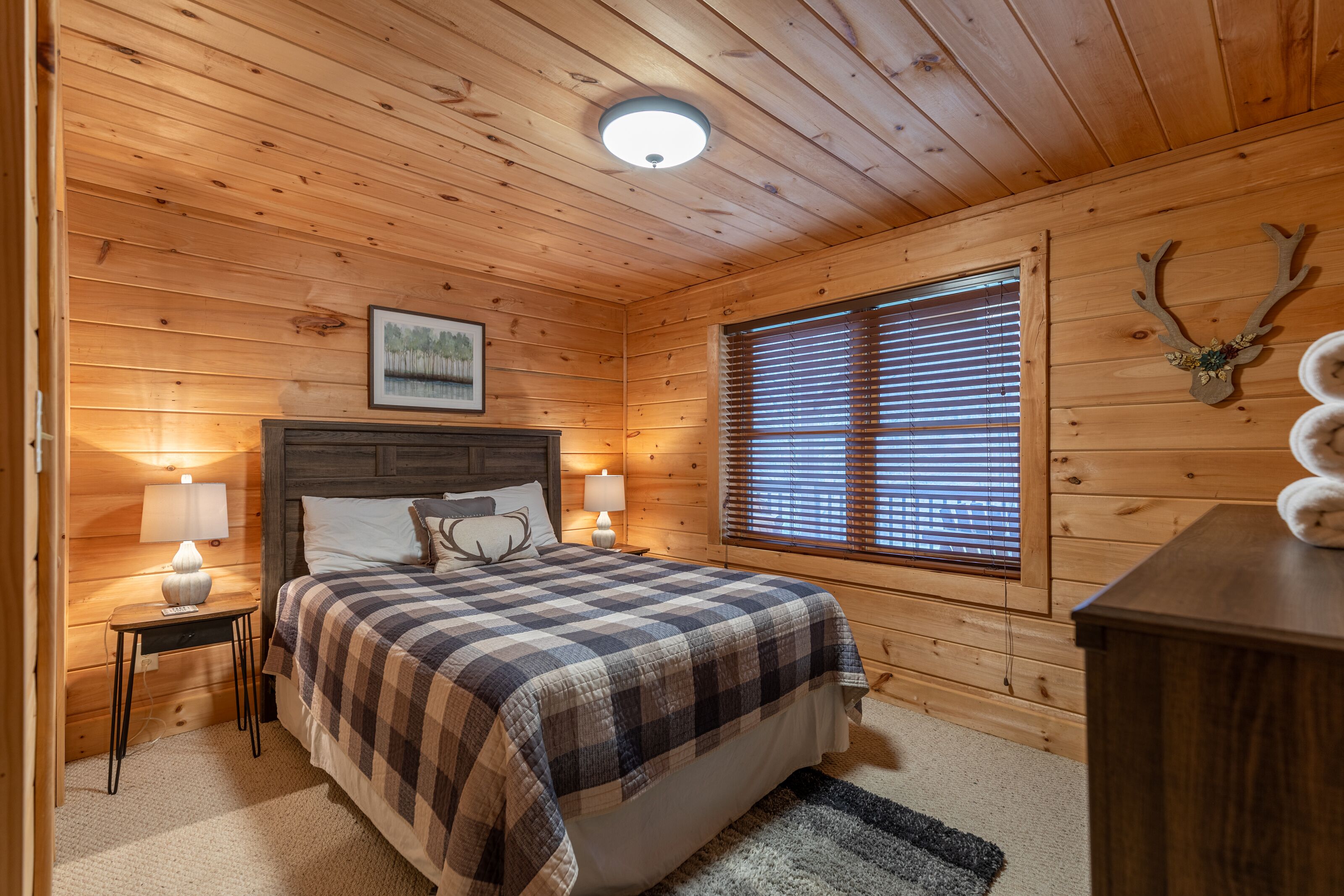 Rustic charm meets restful comfort in this wood-paneled bedroom at Lakeview, tucked in the heart of Valle Crucis.