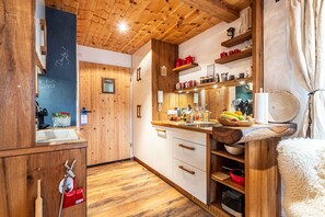 Fridge, stovetop, dishwasher, coffee/tea maker
