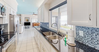Waterfront condo with pool, private dock, amazing views & patio - walk to beach