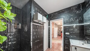 A modern bathroom with a black and white color scheme, a sink, and a mirror. - Holiday Home "Townhouse Can Miquel" with Pool, Garden and Wi-Fi (Sa Pobla)