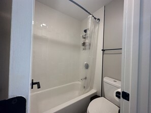 Bathroom features a bathtub, toilet, and shower.