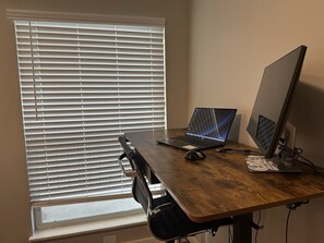 Work in comfort with a desk near a window and a chair for focus.