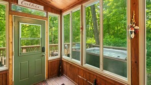 A cabin with a green door, large windows, and a sign that reads "Gather." - Great Location 4 minutes from Patoka Lake Entrance with Hot Tub! (Birdseye)