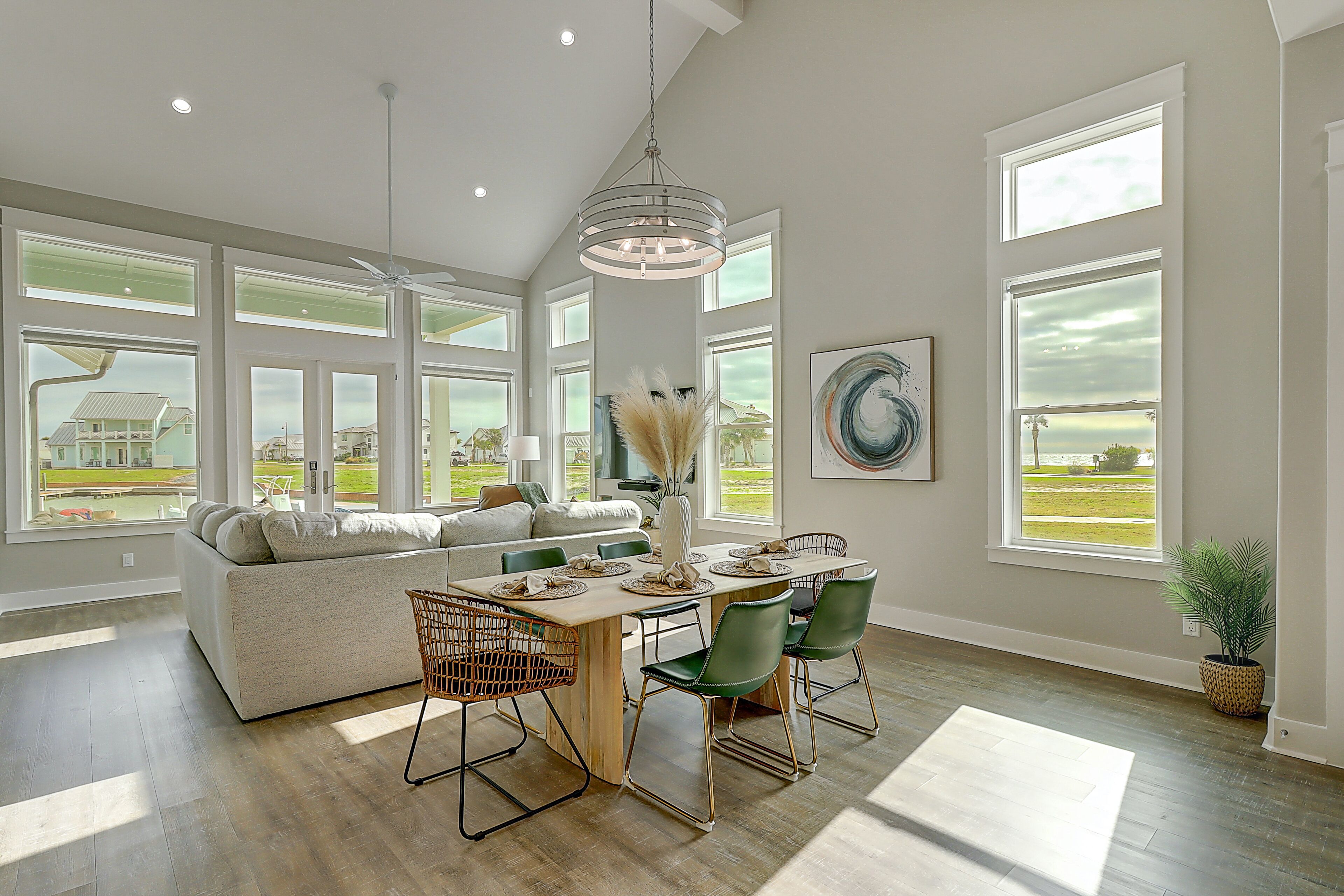 Modern bayfront home with private dock & access to a pool & firepit