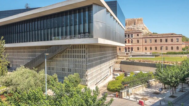 A modern building with a glass facade and a traditional brick structure in the background. - Classic Athenean Apartment at Acropolis Museum & Metro (Athens)