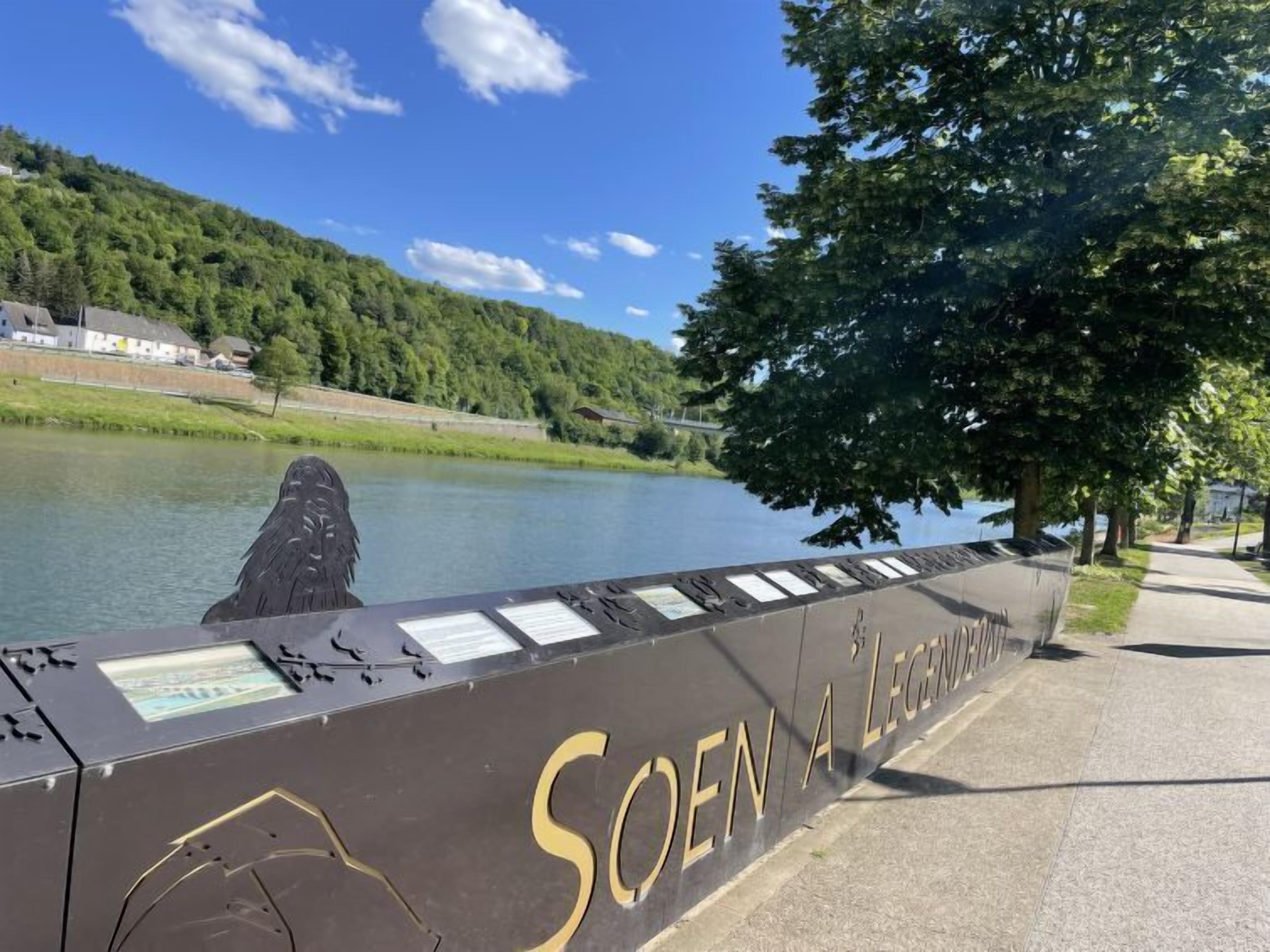 A waterfront walkway with a sign reading "SOEN A LEGEND."