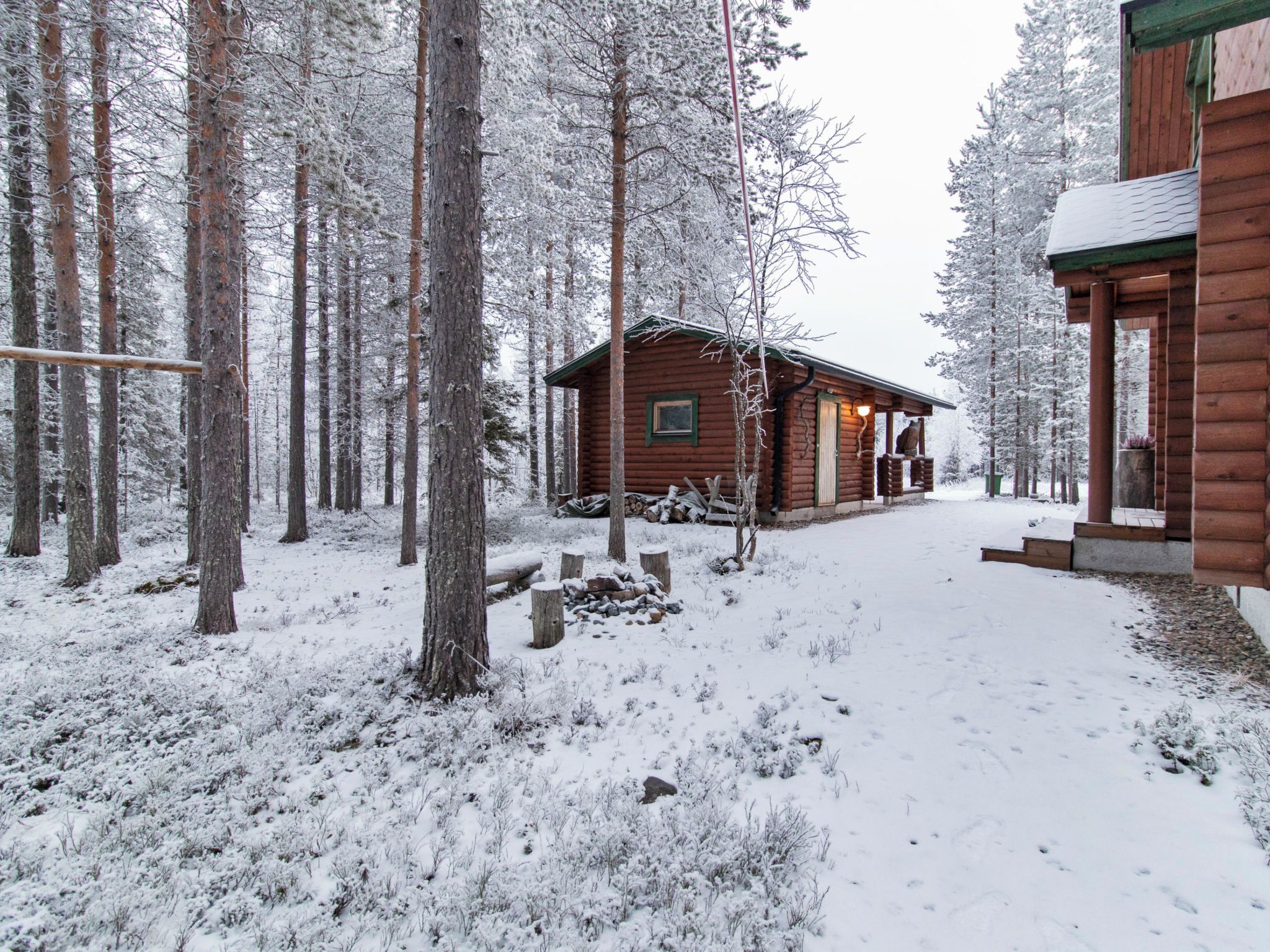 A cabin surrounded by snow-covered trees.