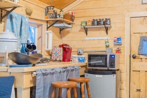 Microwave, coffee/tea maker, cookware/dishes/utensils, dining tables