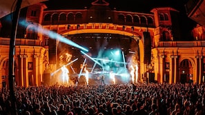 Experience live music in a grand, historic setting with ornate columns and an arched entrance.