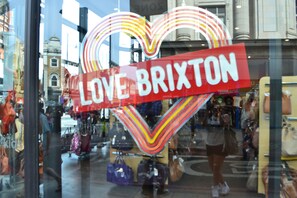 A storefront with a prominent 'LOVE BRIXTON' sign. - Charming Luxury Holiday Stay in Beautful Location (London)
