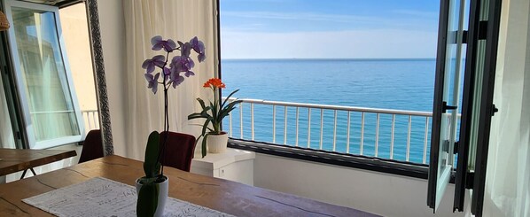 A balcony with a view of the sea, a wooden table, and potted plants. - Ref: 307 Modern beachfront apartment in Torreblanca with stunning sea views (Fuengirola)