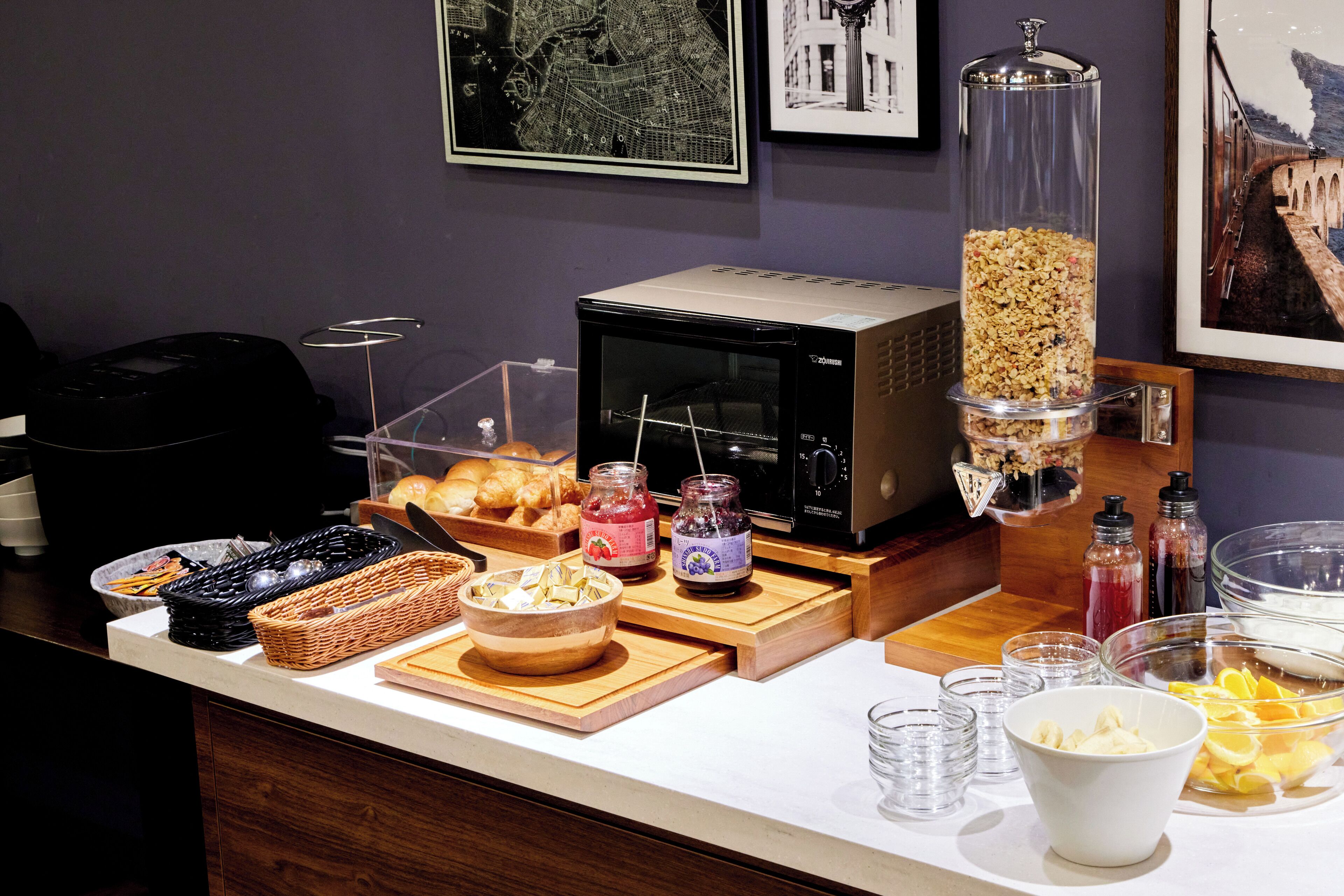 A breakfast buffet with various food items, a microwave, and a coffee machine.