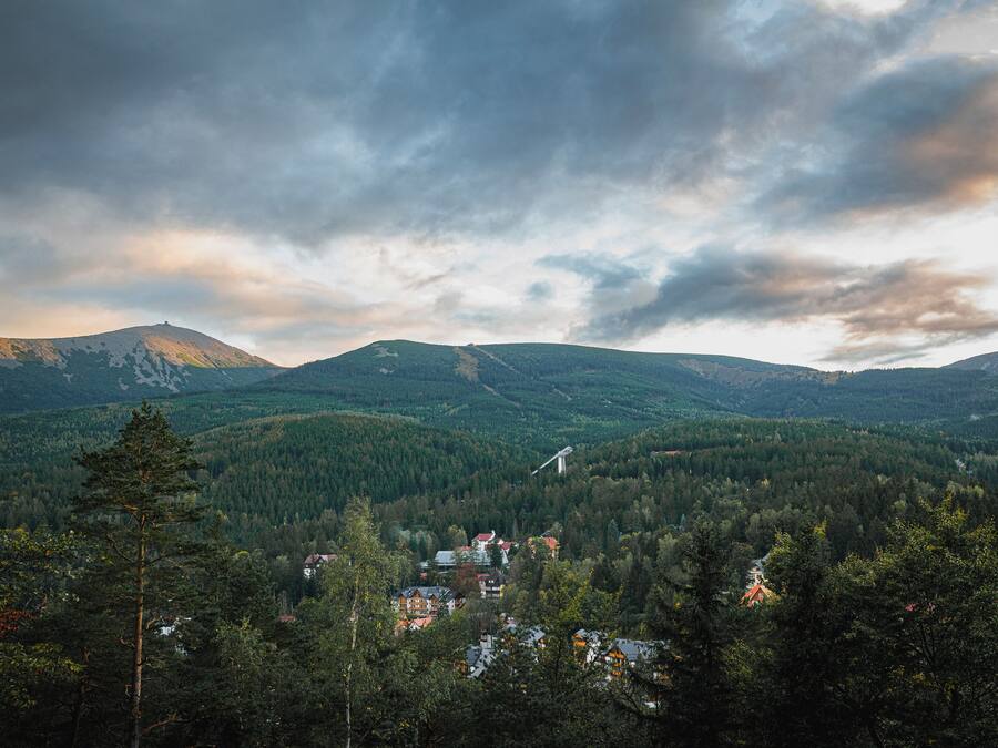 A mountainous landscape with a village nestled among the trees.