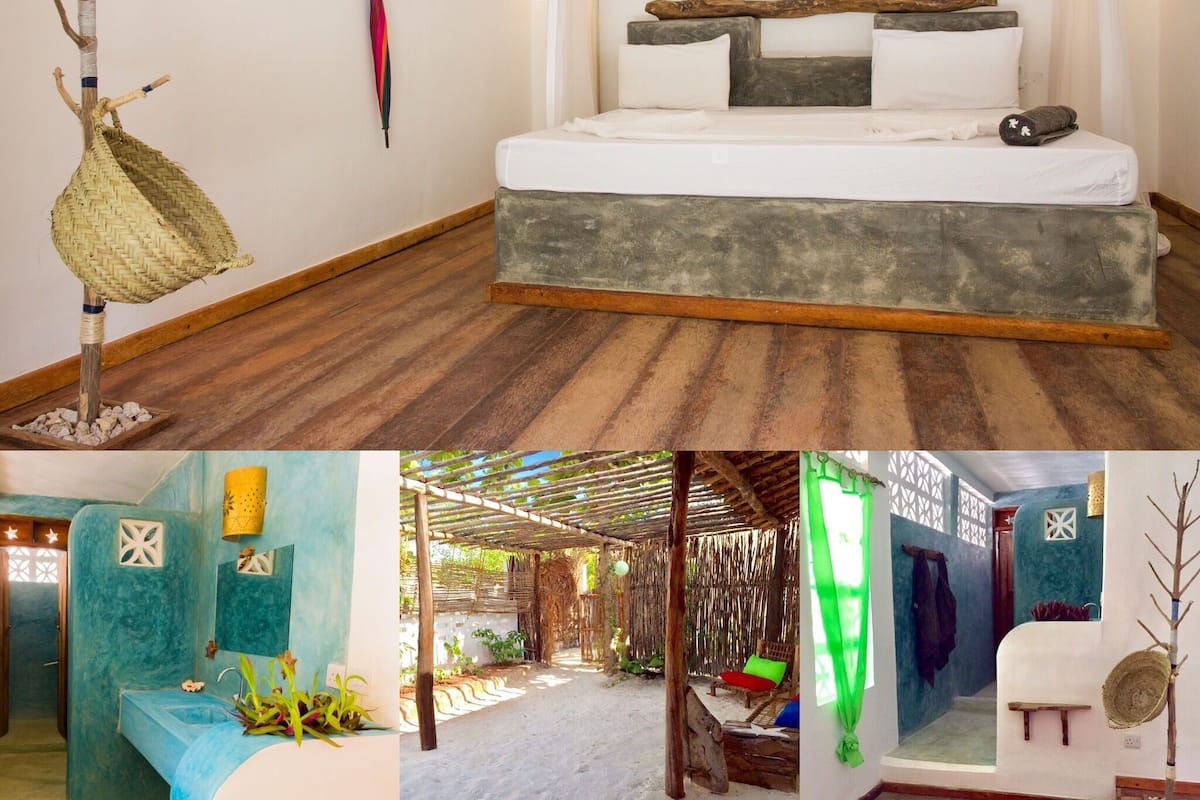 A bedroom with a bed, a hanging chair, and a wall-mounted umbrella.