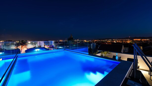 A rooftop swimming pool with a cityscape view at night. - La Vie Villa Jelena with rooftop pool, Zadar county (Zadar)