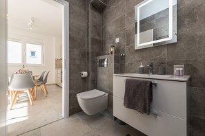 Shower, hair dryer, towels, toilet paper