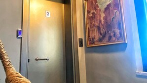 An elevator with a digital display, a door with a handle, and a number 2 sign. - Nomad Hostel Karakoy (Istanbul)