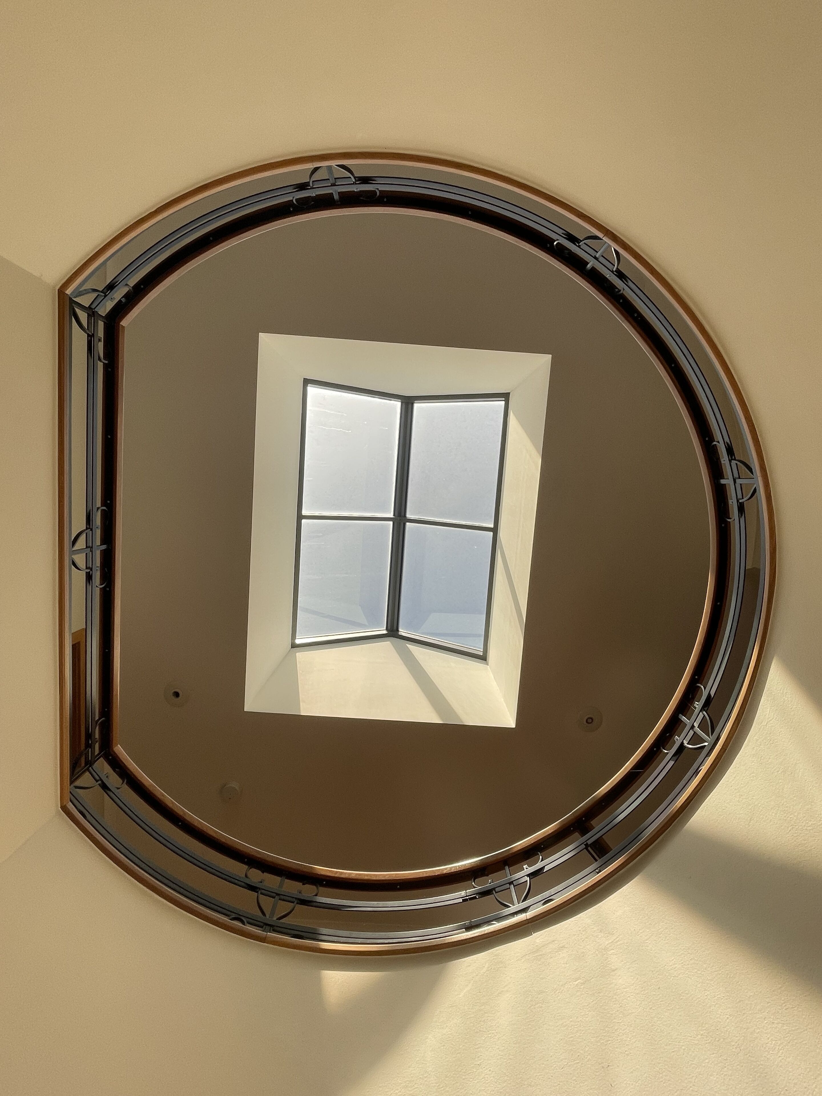 A skylight with a window, surrounded by a circular frame.