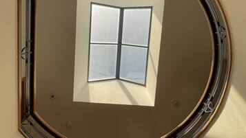 A skylight with a window, surrounded by a circular frame.